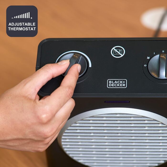 Компактний обігрівач потужністю 2000 Вт Регульовані рівні потужності 3 режими роботи Регульований електронний термостат Система захисту від перекидання Матово-чорний та сірий 2000 Вт Компактний, 2003E