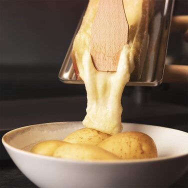 Чорний. Потужність 600 Вт, функція гриля, обробка з нержавіючої сталі, регульований термостат, 2 дерев'яні лопатки, решітка для гриля з антипригарним покриттям, 6000